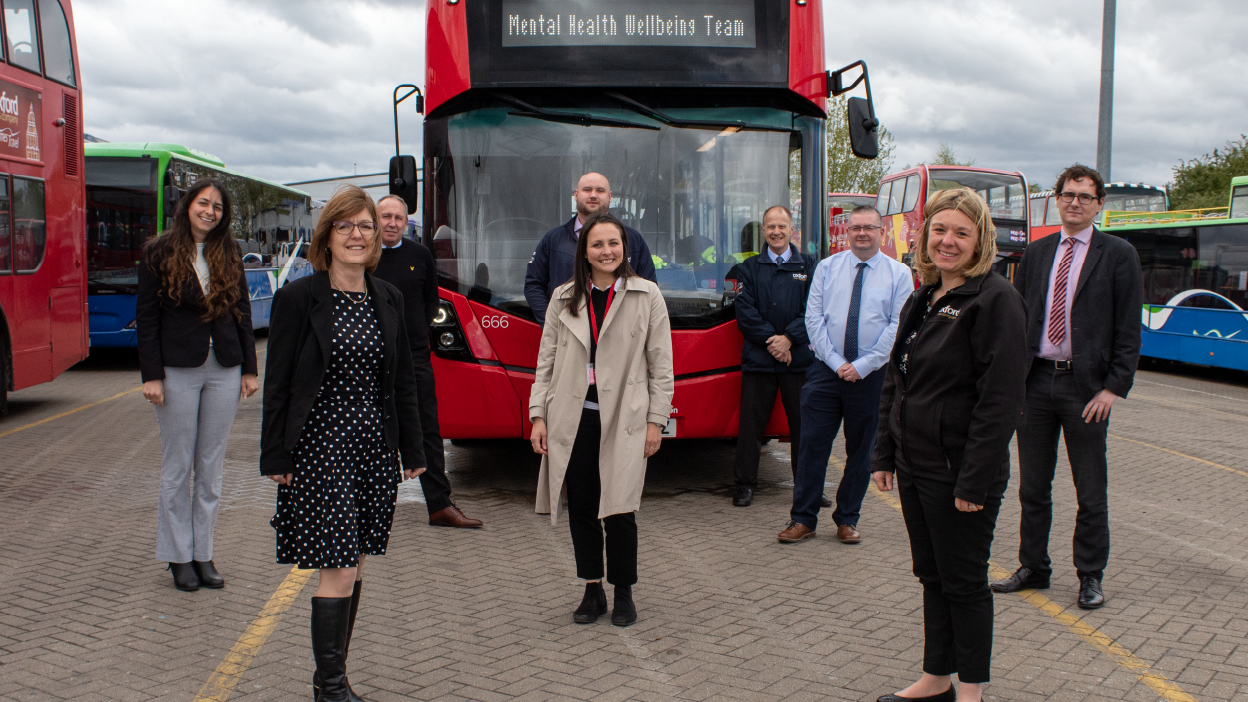 Photo of Carousel Buses wellbeing support team in front of a double decker bus
